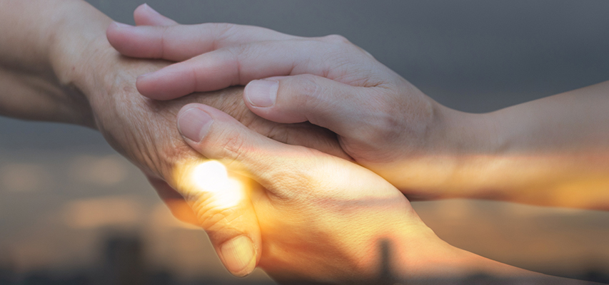 prayer library for end of life care training image of patient holding hands with loved one by project compassion