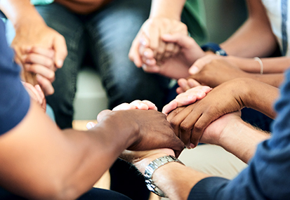 prayer library for end of life care training image of a group holding hands by project compassion