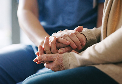 contact us for end of life care training image of a holding hands by project compassion