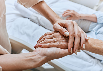 intro to palliative care end of life care training image of patients hand being held by project compassion